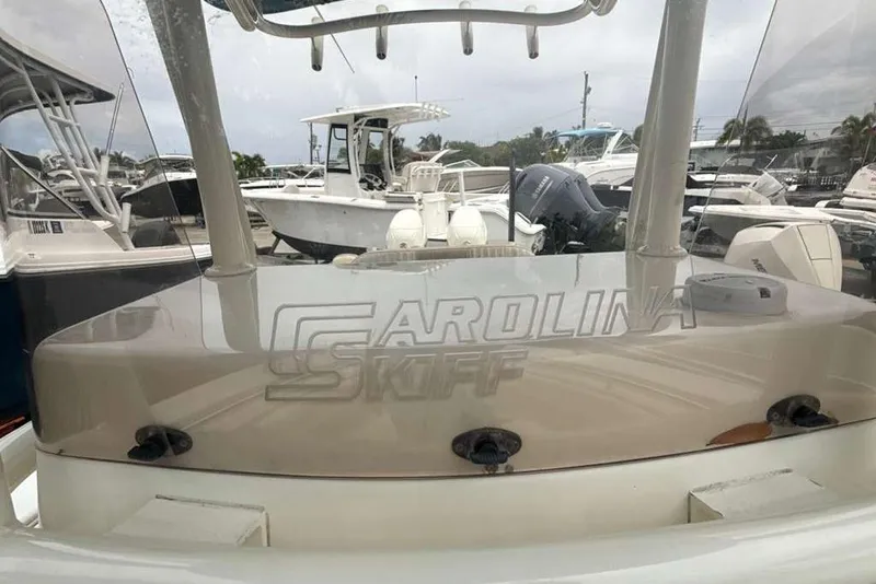 Slide: The Image of 2017 Sea Chaser 24 HFC boat at marina, featuring Carolina Skiff branding. - 10