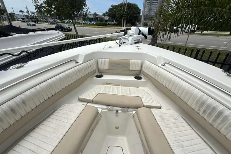 Slide: The Image of 2017 Sea Chaser 24 HFC boat interior with cushioned seating and cup holders. - 11