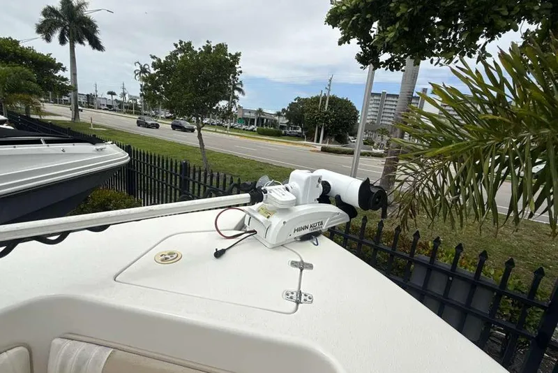Slide: The Image of 2017 Sea Chaser 24 HFC boat with Minn Kota trolling motor, parked near a road. - 13