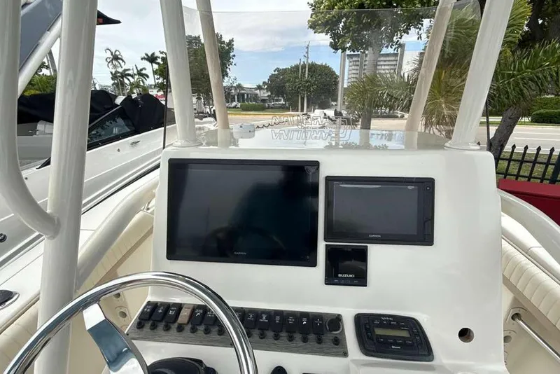 Slide: The Image of 2017 Sea Chaser 24 HFC boat dashboard with navigation screens and controls. - 18