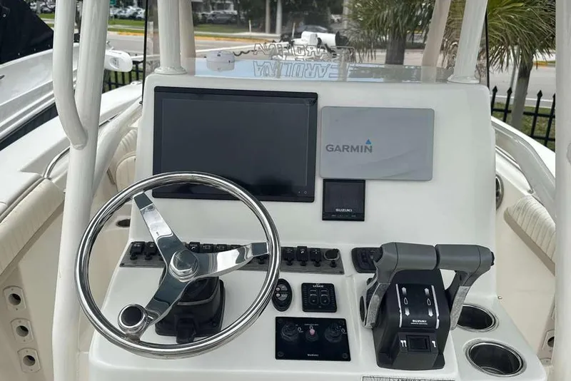 Slide: The Image of 2017 Sea Chaser 24 HFC boat dashboard with Garmin navigation system and controls. - 24
