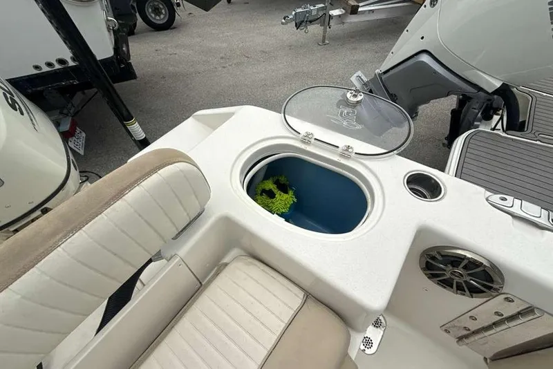 Slide: The Image of 2017 Sea Chaser 24 HFC boat interior with seating, storage compartment, and speaker. - 28