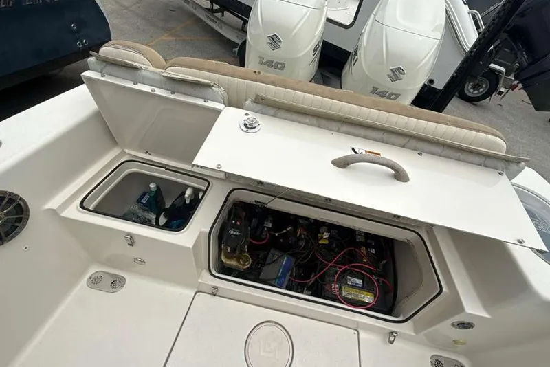 Slide: The Image of 2017 Sea Chaser 24 HFC boat with open storage compartments and visible engine components. - 29