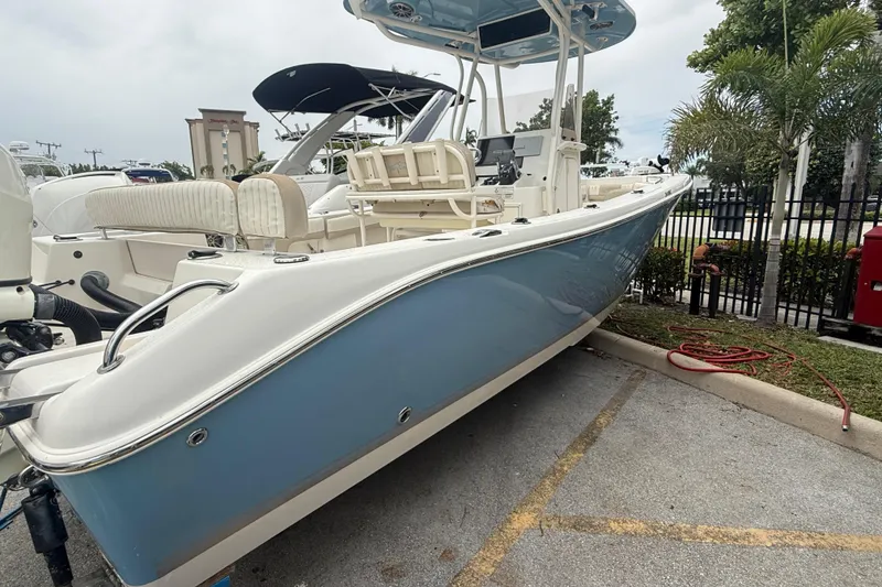Slide: The Image of 2017 Sea Chaser 24 HFC boat with blue hull, parked outdoors. - 3