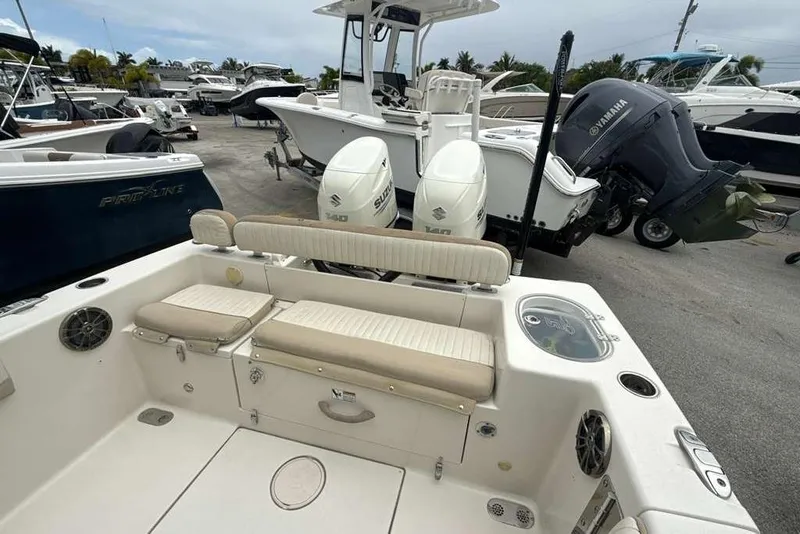 Slide: The Image of 2017 Sea Chaser 24 HFC boat with dual Suzuki outboard motors in a marina. - 32