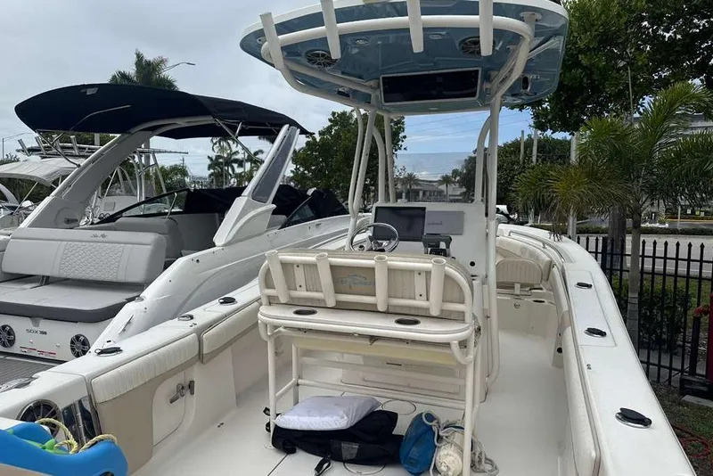 Slide: The Image of 2017 Sea Chaser 24 HFC boat with center console and seating, docked near other boats. - 33