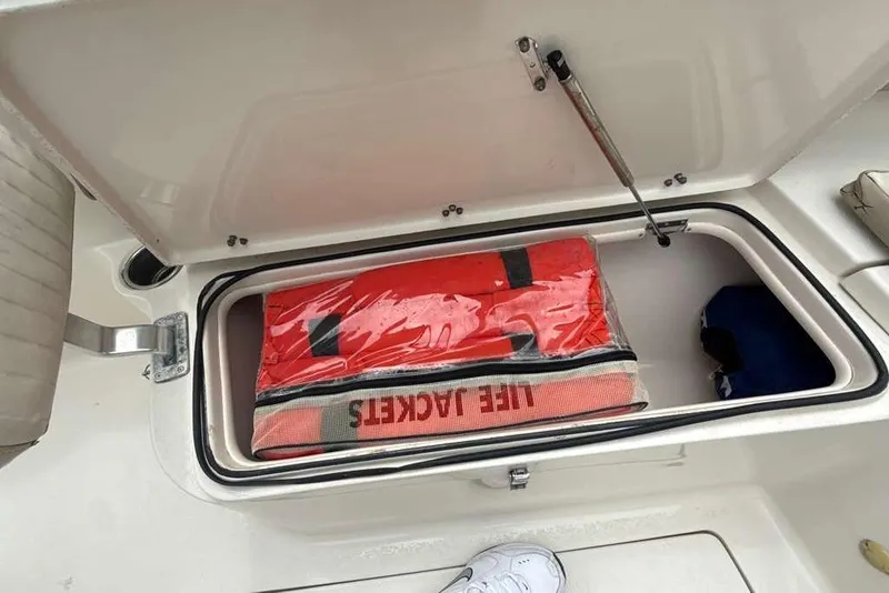 Slide: The Image of Storage compartment on a 2017 Sea Chaser 24 HFC boat with life jackets inside. - 6