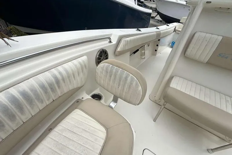 Slide: The Image of 2017 Sea Chaser 24 HFC boat interior with cushioned seating and cup holder. - 8
