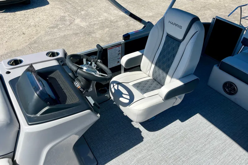 Slide: The Image of Interior of 2025 Harris Sunliner 210 boat with luxurious captain's chair. - 11