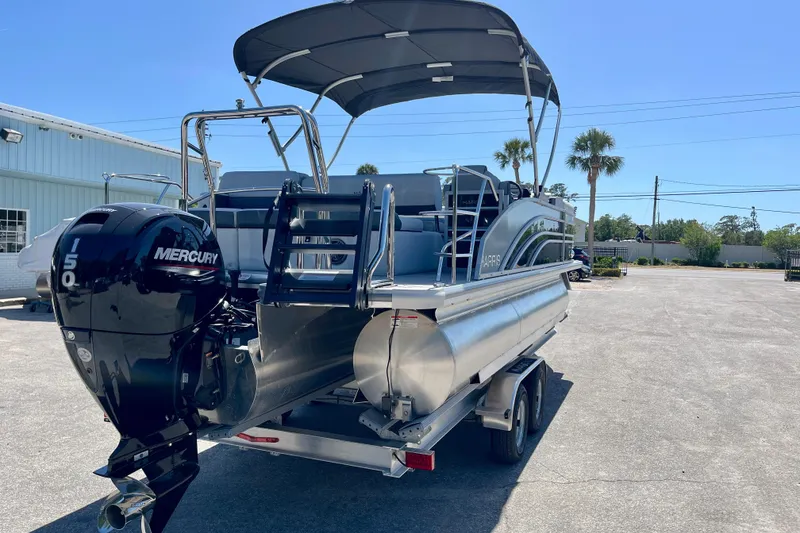 Slide: The Image of 2025 Harris Sunliner 210 pontoon boat with Mercury engine on trailer. - 4