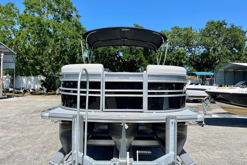 Slide: The Image of Harris Sunliner 210 pontoon boat 2025 on trailer outdoors. - 7