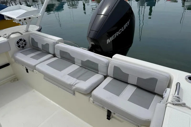 Slide: The Image of 2024 Mako 214 Center Console boat with cushioned seating and Mercury outboard motor. - 11