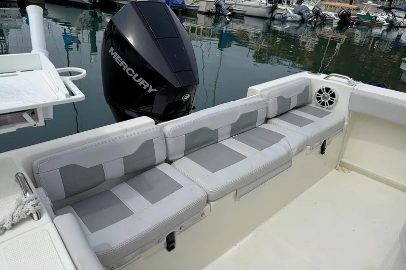 Slide: The Image of 2024 Mako 214 Center Console boat with Mercury engine, featuring comfortable seating. - 12