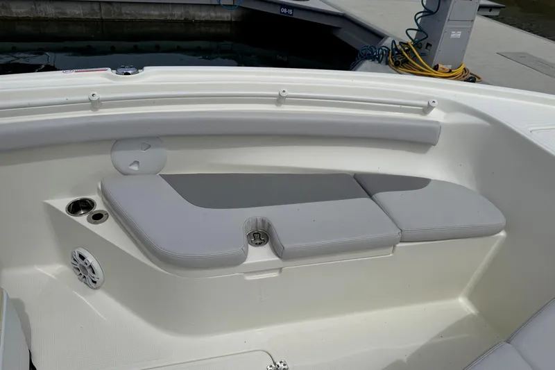 Slide: The Image of 2024 Mako 214 Center Console boat interior with cushioned seating and cup holders. - 23