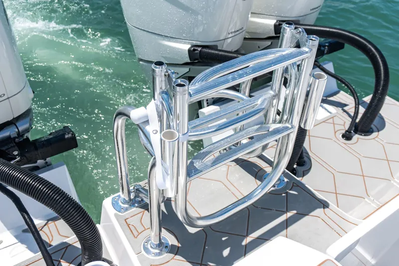 Slide: The Image of 2026 Twin Vee 340 GFX CC boat with stainless steel rod holders and dual outboard motors. - 17