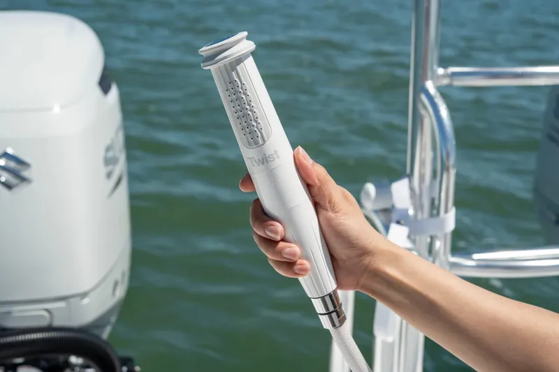 Slide: The Image of Hand holding a Twist showerhead on a 2026 Twin Vee 340 GFX CC boat. - 21