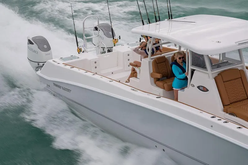 Slide: The Image of Manufacturer Provided Image: 2026 Twin Vee 340 GFX CC cruising on water with passengers, showcasing luxury and performance. - 3