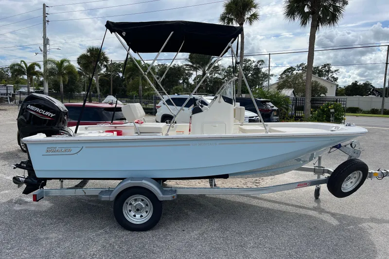 The Image of 2026 Boston Whaler 150 Montauk boat on trailer outdoors. - 1