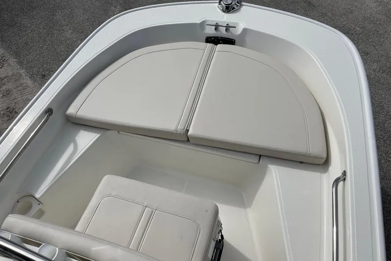 Slide: The Image of Boston Whaler 150 Montauk 2026, front seating area with cushions. - 10