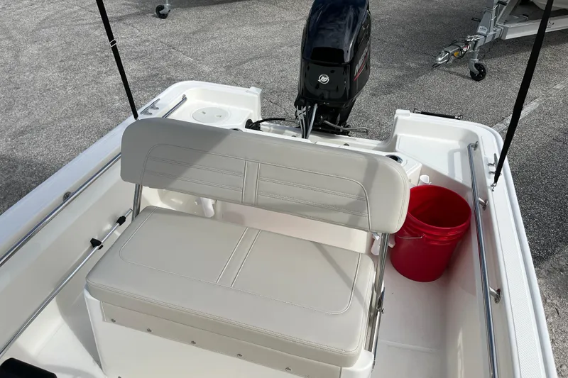 Slide: The Image of Interior of 2026 Boston Whaler 150 Montauk with bench seat and motor. - 12