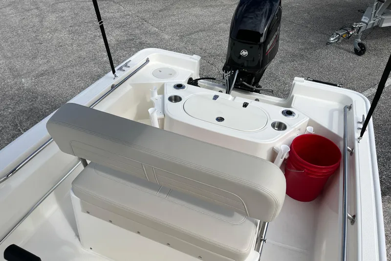 Slide: The Image of Interior of 2026 Boston Whaler 150 Montauk with motor and red bucket. - 13