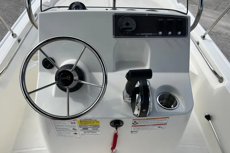 Slide: The Image of Steering console of the 2026 Boston Whaler 150 Montauk. - 14
