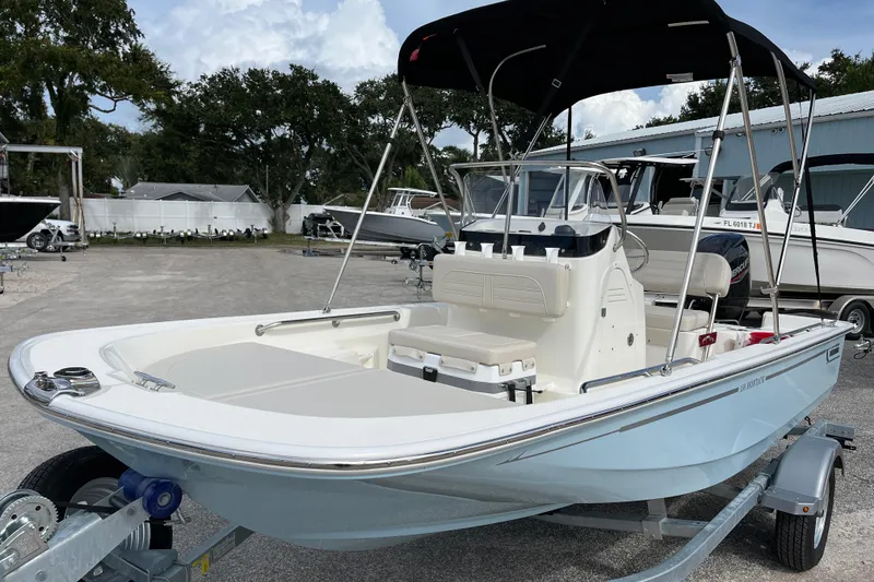 Slide: The Image of 2026 Boston Whaler 150 Montauk boat on trailer outdoors. - 4