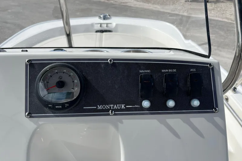 Slide: The Image of Dashboard of 2026 Boston Whaler 150 Montauk with tachometer and switches. - 9