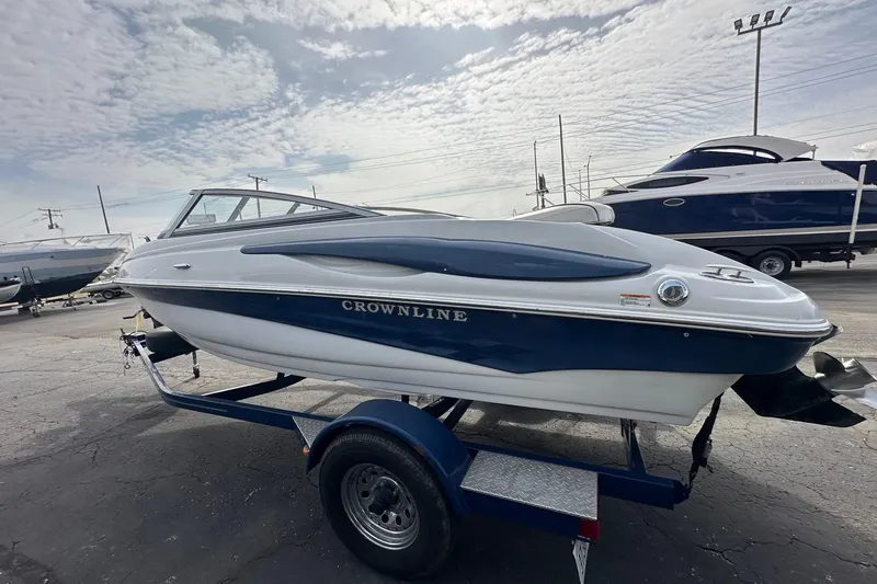 Slide: The Image of 2007 Crownline 19 SS boat on trailer under cloudy sky. - 2