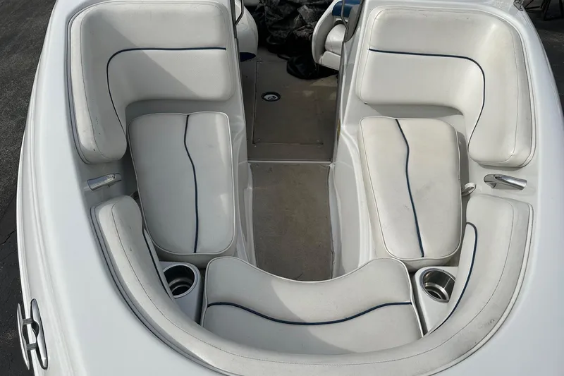 Slide: The Image of 2007 Crownline 19 SS boat interior with white cushioned seating and cup holders. - 9