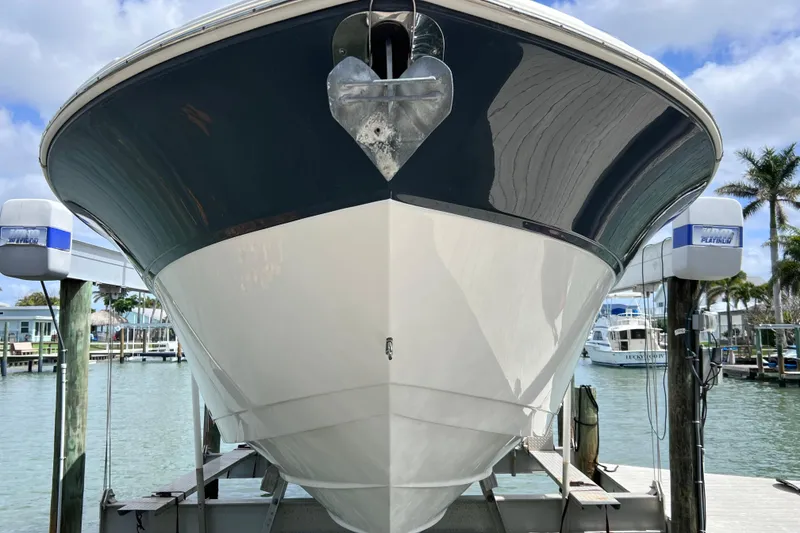 Slide: The Image of 2019 Sea Fox 328 Commander boat docked, showcasing sleek hull design. - 11
