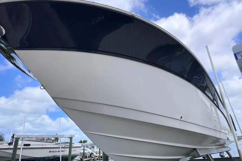 Slide: The Image of 2019 Sea Fox 328 Commander boat with sleek design against a blue sky backdrop. - 13