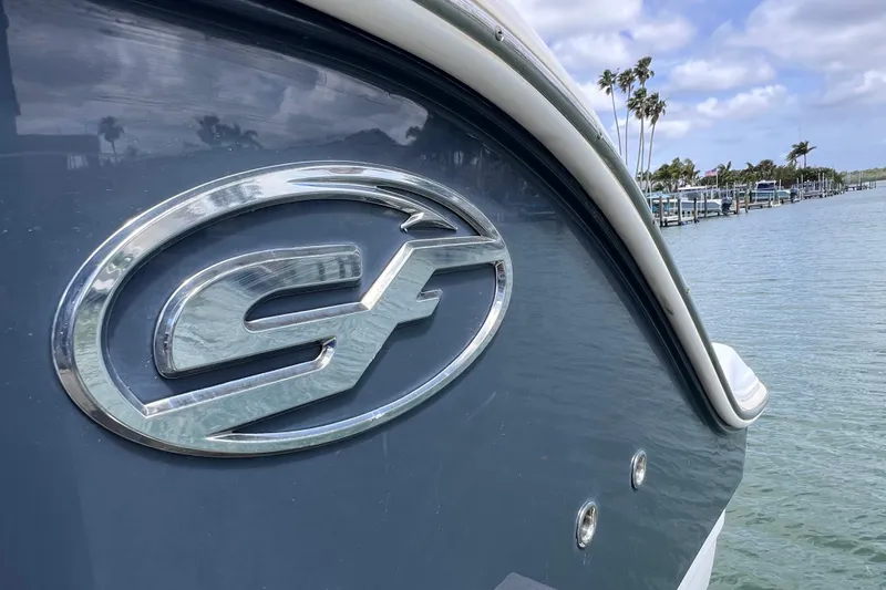 Slide: The Image of 2019 Sea Fox 328 Commander boat with logo, docked by palm trees. - 15