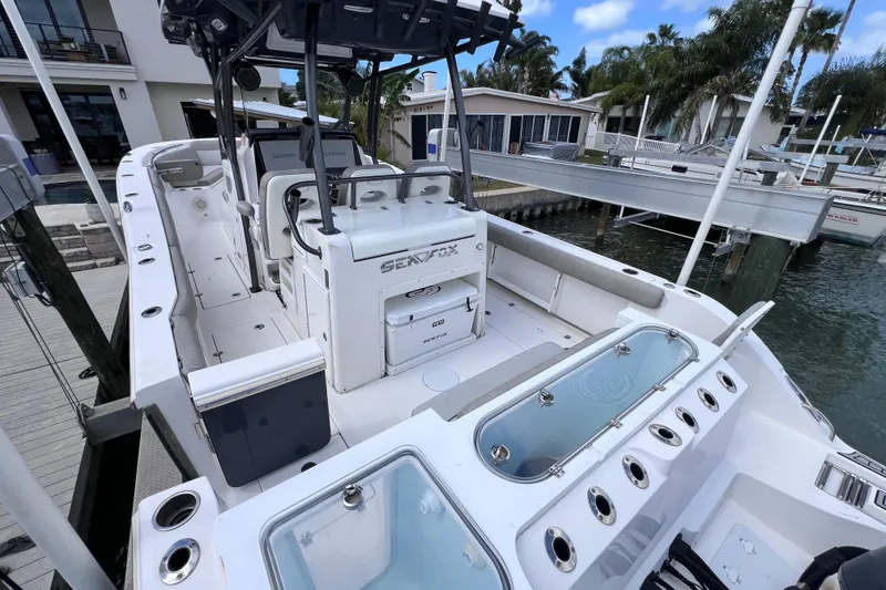 Slide: The Image of 2019 Sea Fox 328 Commander boat docked, showcasing spacious deck and modern amenities. - 18