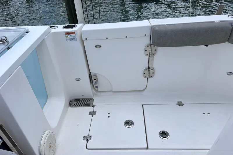 Slide: The Image of 2019 Sea Fox 328 Commander boat deck with storage compartments and seating. - 21