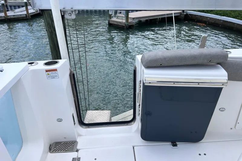 Slide: The Image of 2019 Sea Fox 328 Commander boat interior with open door, dockside view. - 22