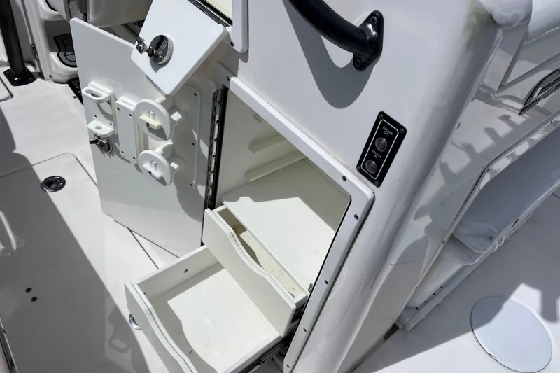 Slide: The Image of 2019 Sea Fox 328 Commander boat storage compartment with open drawers and control panel. - 27