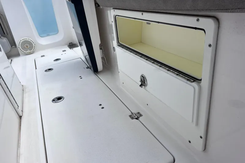 Slide: The Image of Interior view of 2019 Sea Fox 328 Commander boat, featuring storage compartment and speaker. - 28