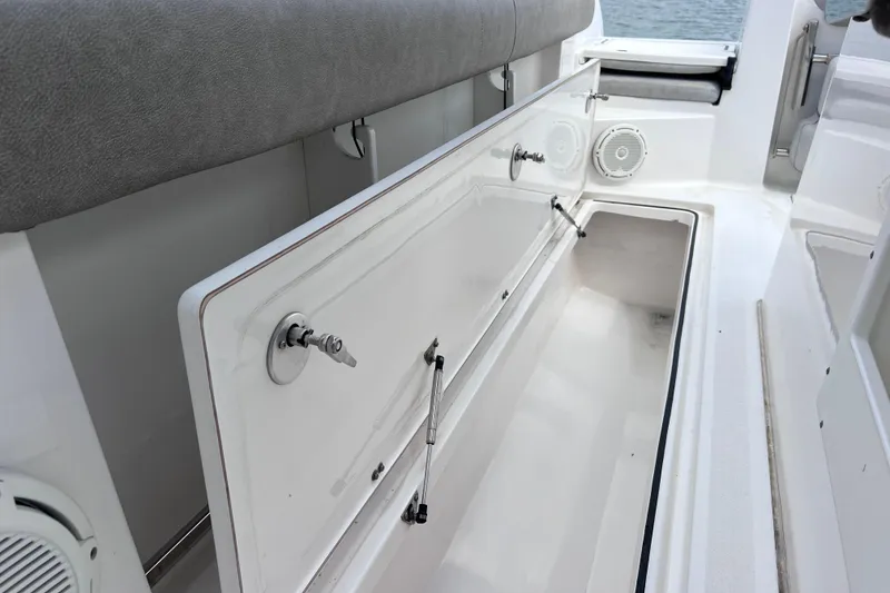 Slide: The Image of 2019 Sea Fox 328 Commander boat storage compartment with open hatch and seating. - 29