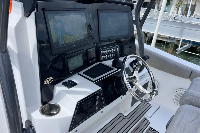 Slide: The Image of 2019 Sea Fox 328 Commander boat dashboard with advanced navigation displays and steering wheel. - 33