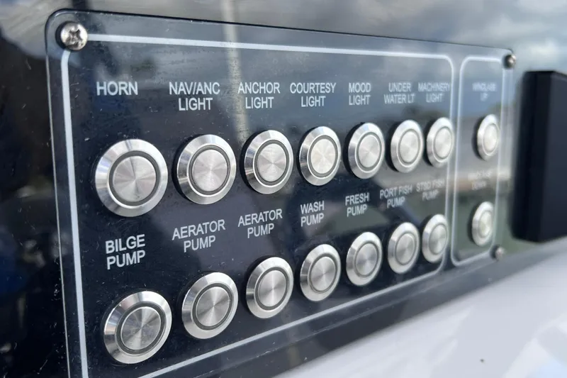 Slide: The Image of Control panel of a 2019 Sea Fox 328 Commander boat with labeled buttons. - 42