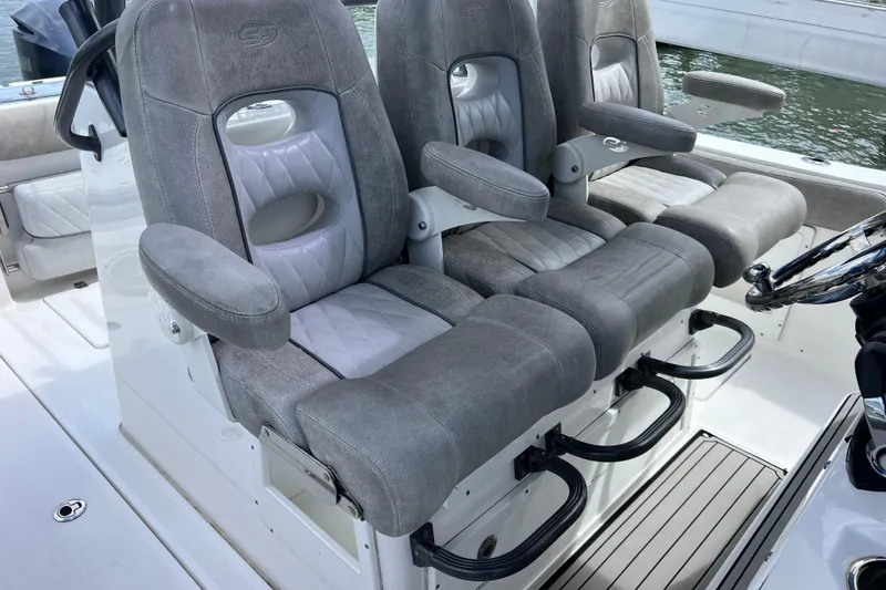 Slide: The Image of 2019 Sea Fox 328 Commander boat seats with armrests, featuring gray and white upholstery. - 44