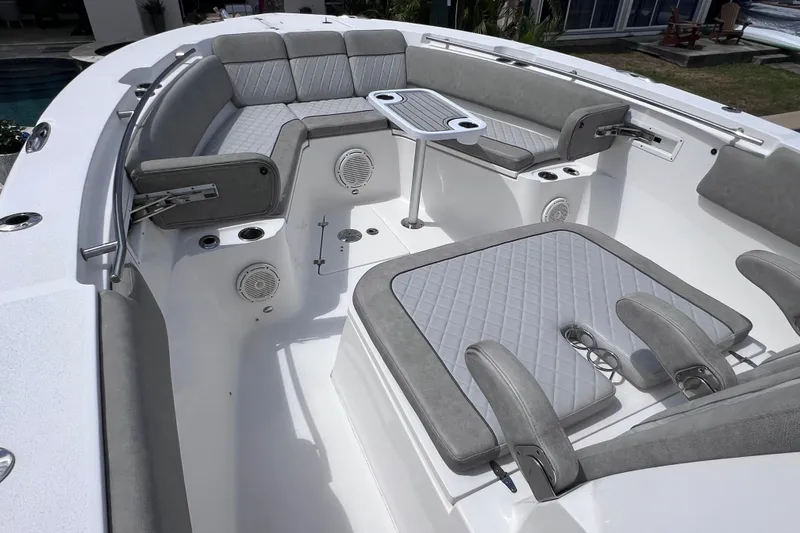 Slide: The Image of 2019 Sea Fox 328 Commander boat interior with cushioned seating and table. - 46