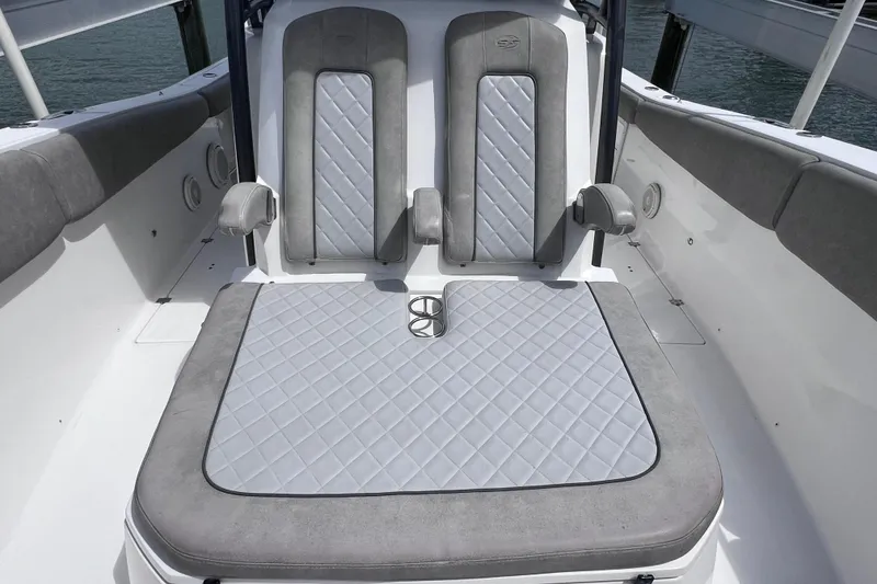 Slide: The Image of 2019 Sea Fox 328 Commander boat seating with gray cushioned upholstery and cup holders. - 51