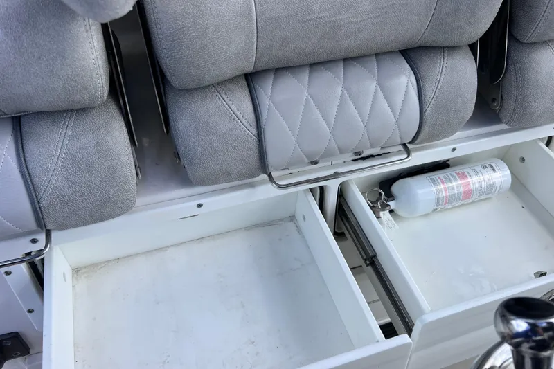 Slide: The Image of 2019 Sea Fox 328 Commander boat interior with storage drawers and fire extinguisher. - 58