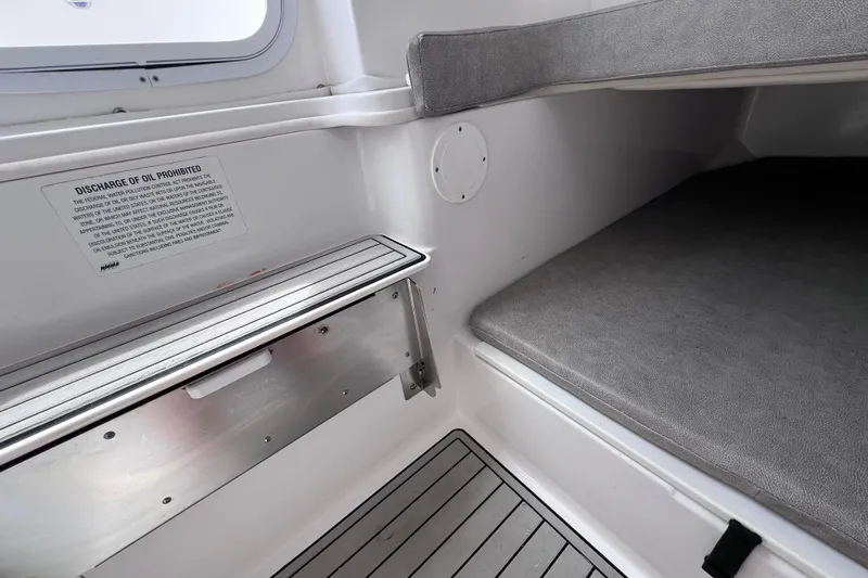Slide: The Image of 2019 Sea Fox 328 Commander cabin interior with gray seating and storage area. - 64