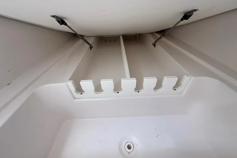 Slide: The Image of 2019 Sea Fox 328 Commander rod storage compartment with secure holders and drainage. - 66