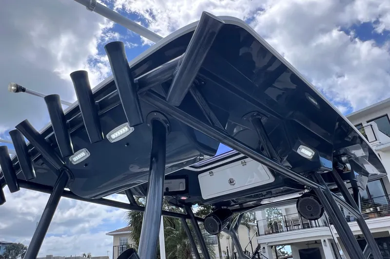 Slide: The Image of 2019 Sea Fox 328 Commander boat with rod holders and speakers under a cloudy sky. - 72