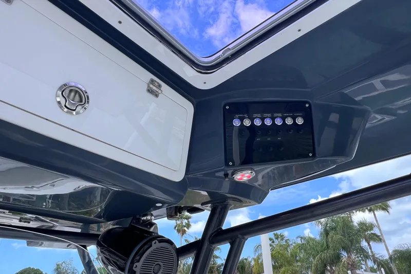 Slide: The Image of 2019 Sea Fox 328 Commander boat interior with control panel and storage compartment. - 77