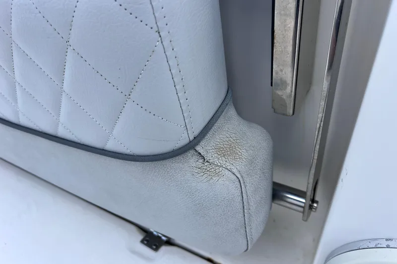 Slide: The Image of Cracked upholstery on 2019 Sea Fox 328 Commander boat seat, showing wear and tear. - 80